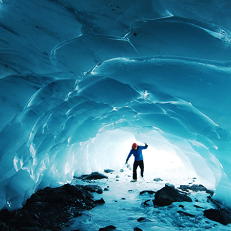 A person enters an ice cave