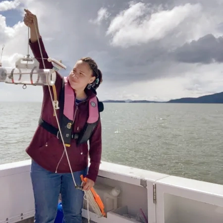 Brandi Kamermans looking at equipment on a boat