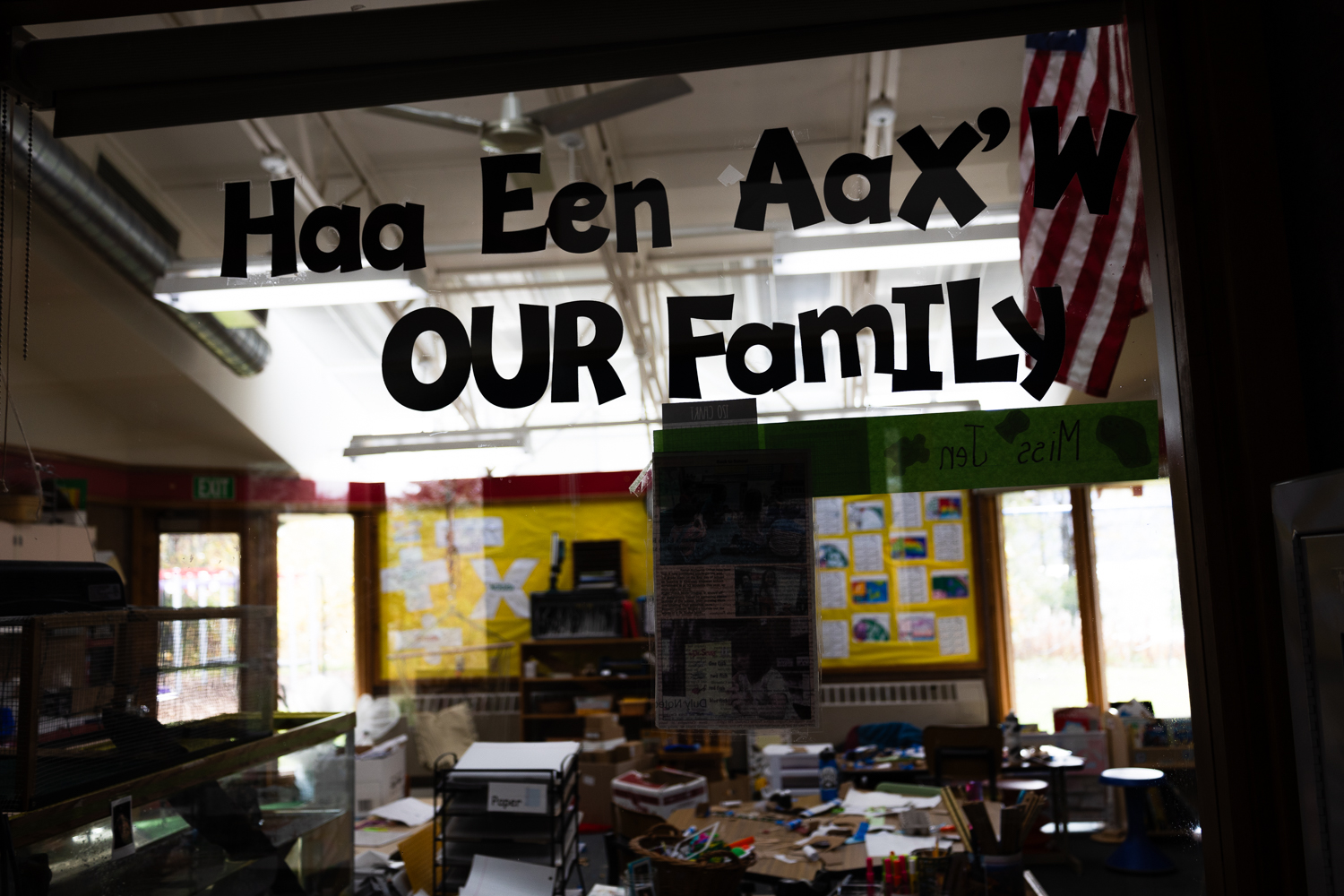 Cut paper letters taped to the window of a classroom at Klukwan School read, "Haa Een Aax'w, Our Family."