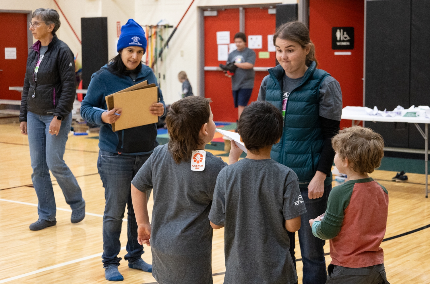 Alaska EPSCoR researchers Emily Whitney and Schery Umanzor listening to students during the Aviation event.