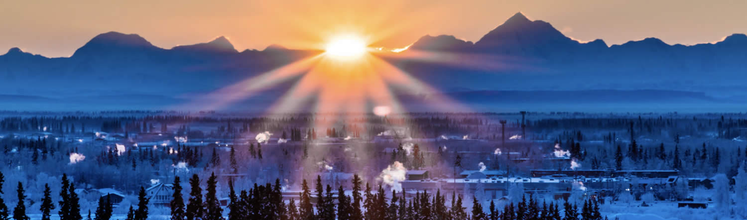 The first rays of sunshine burst over the Alaska Range just before 11 a.m. on a mid-December morning as seen from the UAF campus in Fairbanks.