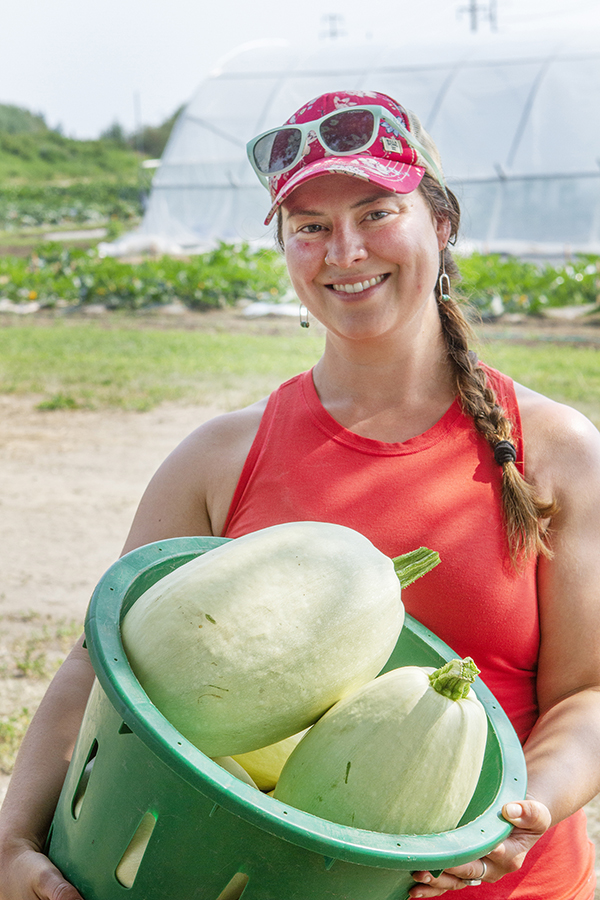 Female researcher holding bucket of squash