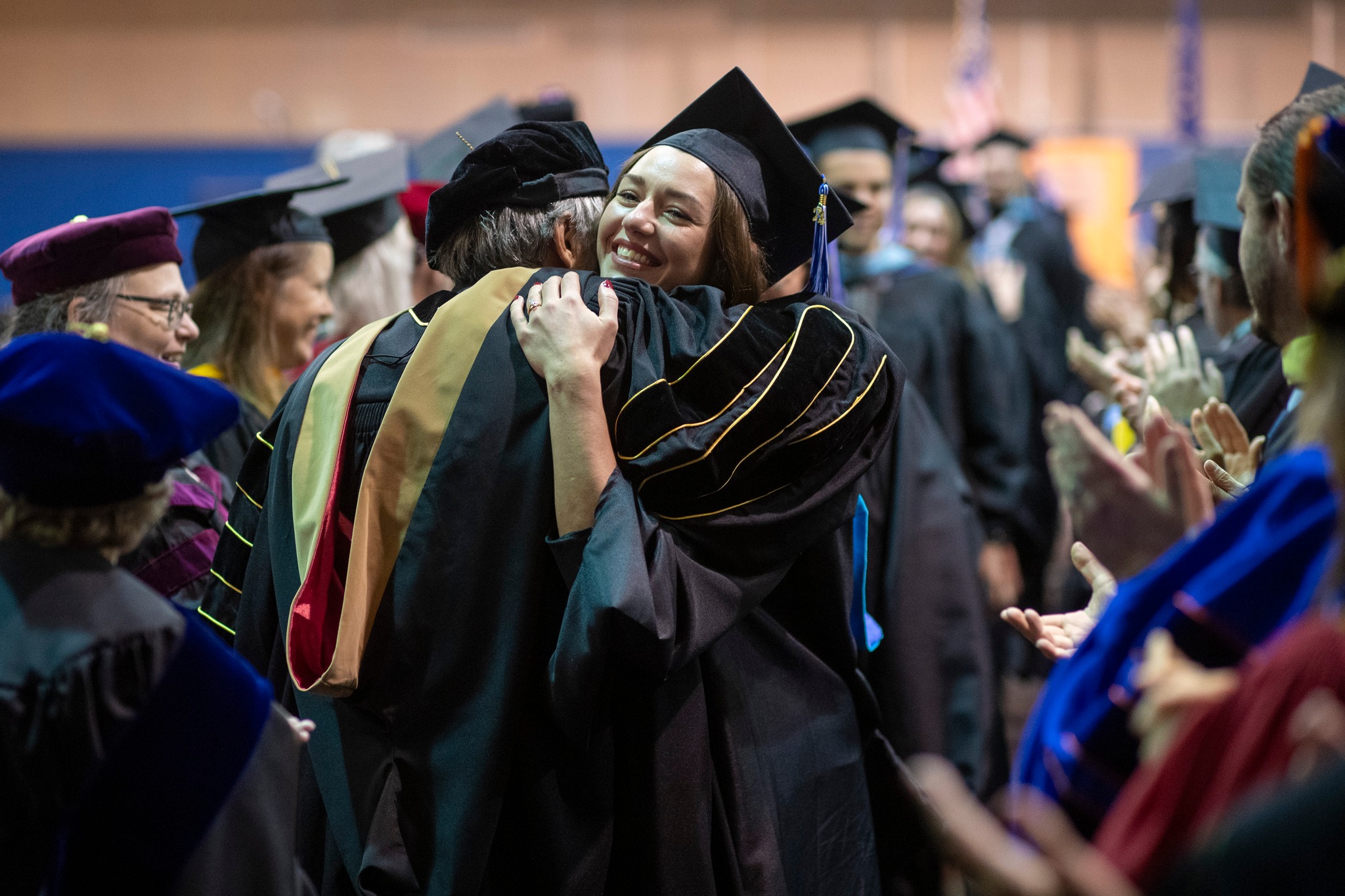 UAA grad hugs a professor as she walks out of ceremony