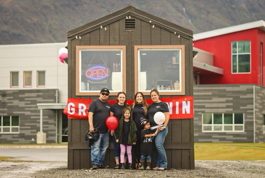 The owners of the drive-through coffee hut Quad Shot, pose with their business in Valdez, Alaska