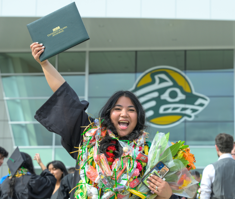 A UAA grad celebrates after the ceremony