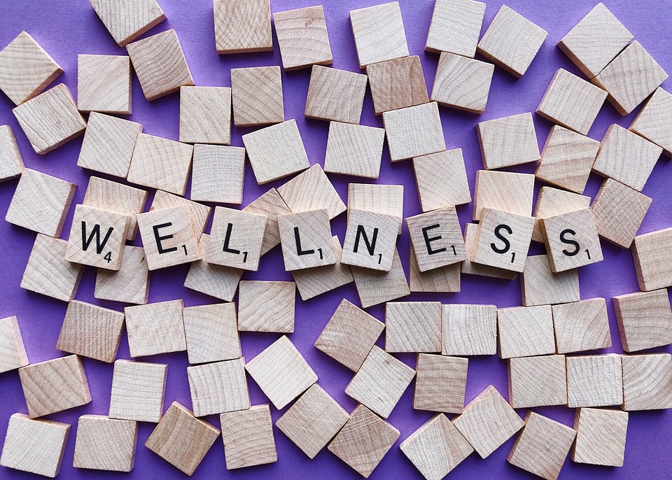 Wellness spelled out in wooden tiles