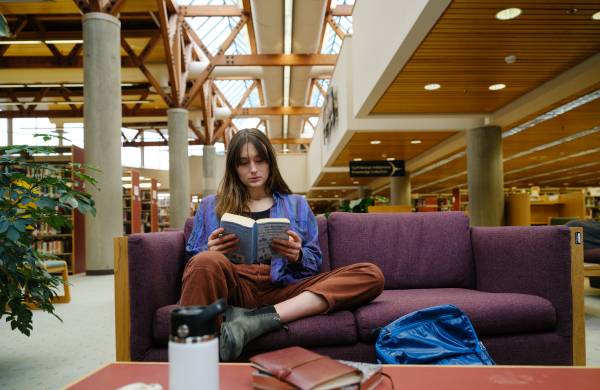 girl sitting, reading a book