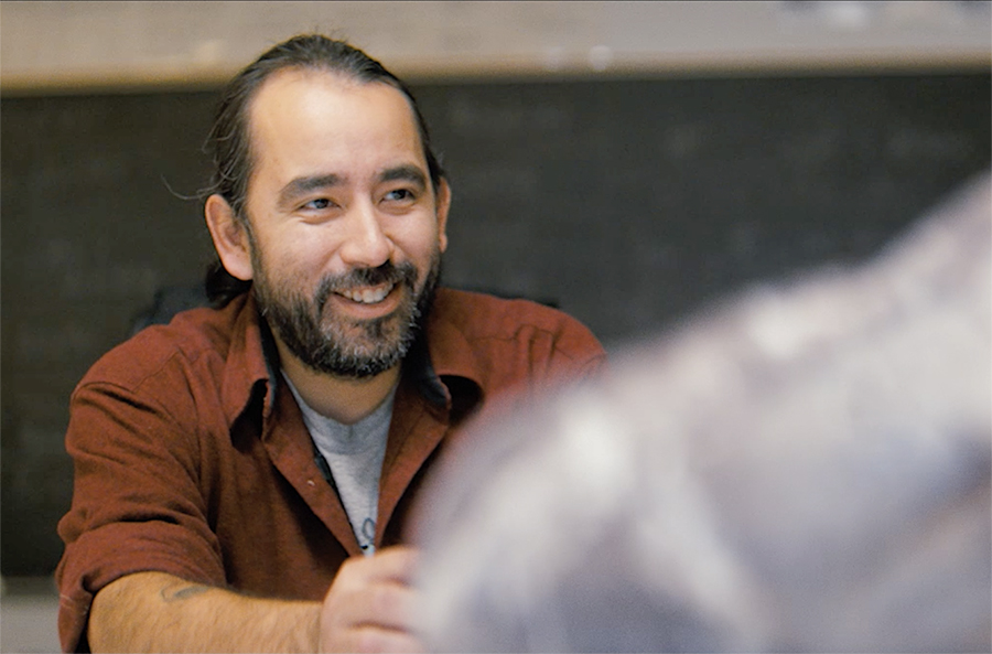 A UA graduate speaks with a student