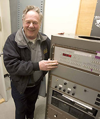Benny Benevento shows the programming unit that works with the piano and bells. 2005 UAF photo by Todd Paris