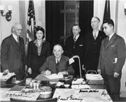 Governor Gruening (seated) signs the anti-discrimination act of 1945. Photo: Alaska State Library