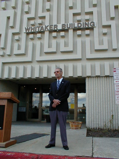 Willard "Buck" Whitaker in front of the Whitaker Building on the Fairbanks Campus
