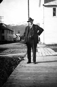 George Love, U.S. Commissioner and insurance agent, in front of his office in the Pioneer Hall, Valdez. Anchorage Musem at Rasmuson Center, Crary-Henderson Collection